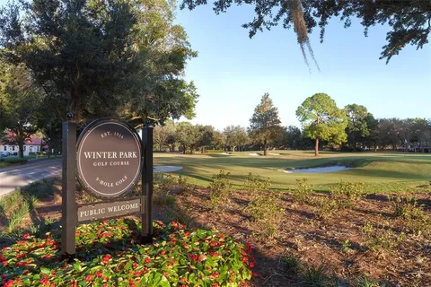 a view of a water fountain in front of retail shop