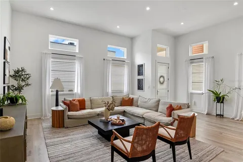 a living room with furniture and wooden floor