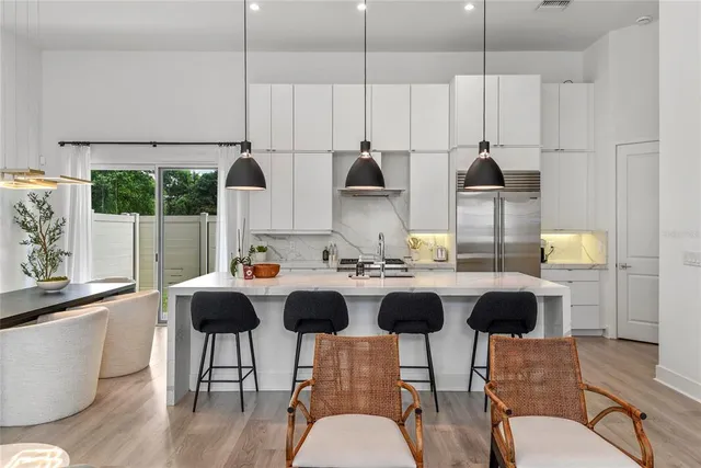 a kitchen with a table chairs stove and kitchen island