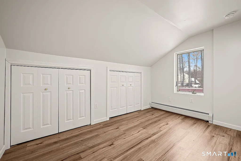 78 Union Street Bristol, CT 06010 - Photo 15 of 27 an empty room with wooden floor and windows