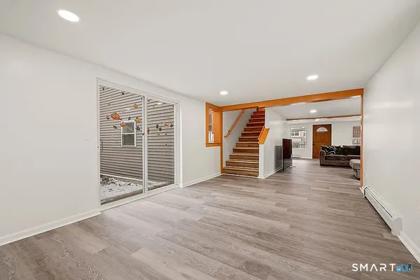 a view of a room with wooden floor and stairs