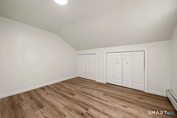 a view of a room with wooden floor