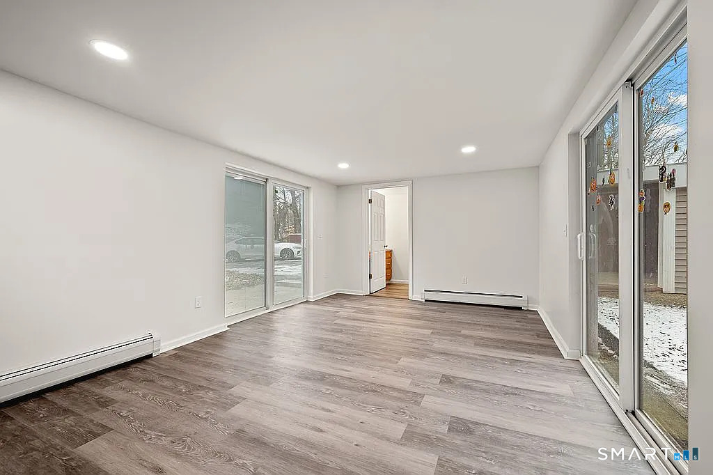 78 Union Street Bristol, CT 06010 - Photo 23 of 27 a view of an empty room with wooden floor and a window