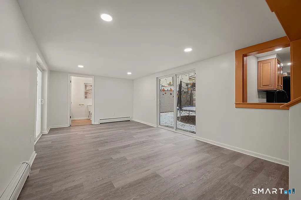 78 Union Street Bristol, CT 06010 - Photo 24 of 27 a view of an empty room with wooden floor and a window