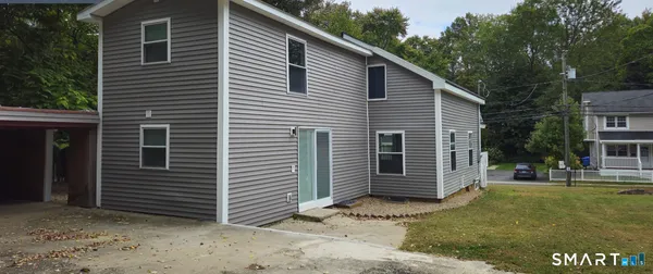a view of a house with a yard