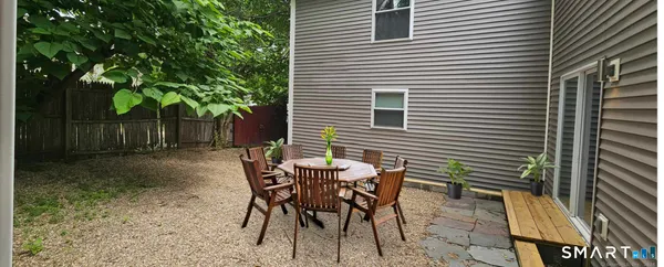 a view of a house with backyard and sitting area