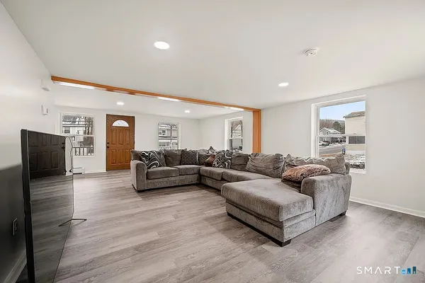 a living room with furniture and a flat screen tv