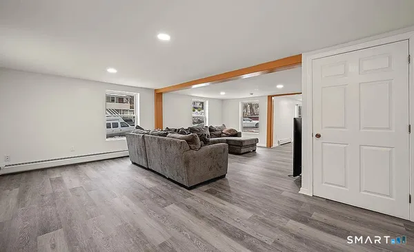 a living room with furniture and a wooden floor
