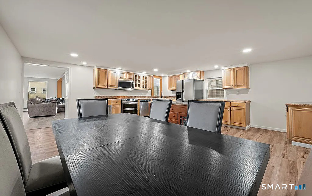 78 Union Street Bristol, CT 06010 - Photo 10 of 27 a view of a kitchen with kitchen island wooden floors and stainless steel appliances