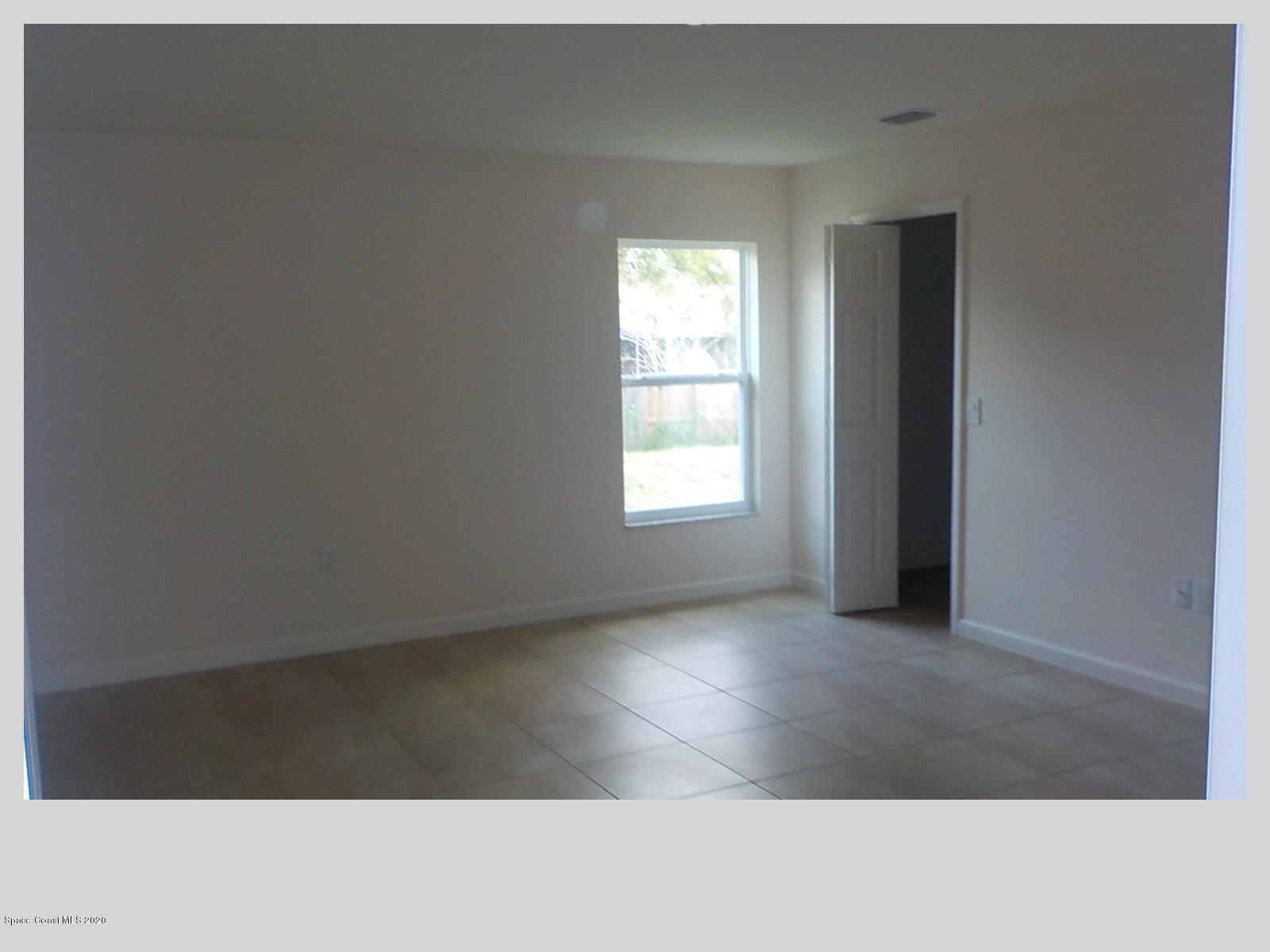 6795 Haddington Road Cocoa, FL 32927 - Photo 10 of 18 a view of an empty room and window