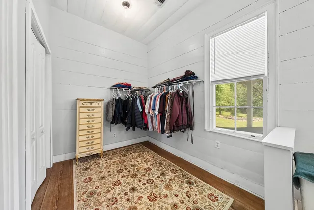 a view of a hallway with a couch and a window