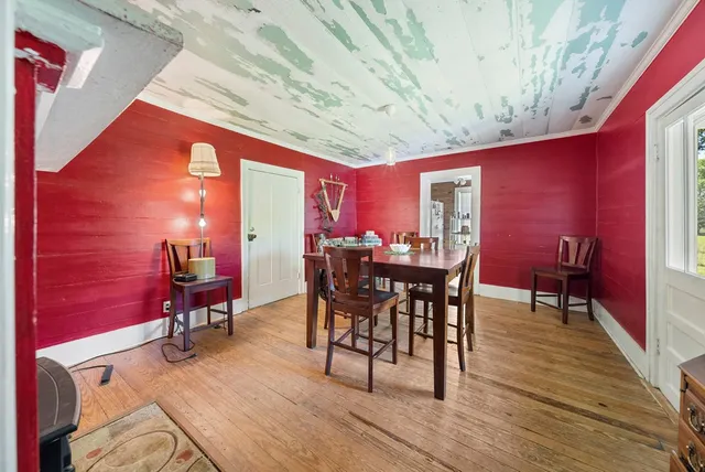 a dining room with furniture and wooden floor