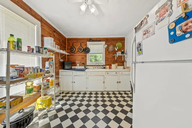 a kitchen with a refrigerator and a stove