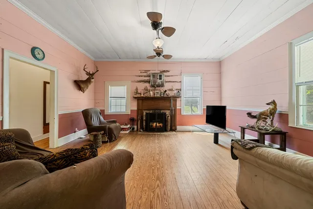 a living room with furniture a fireplace and a chandelier