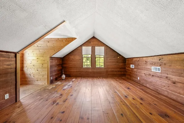 a view of hallway with wooden floor