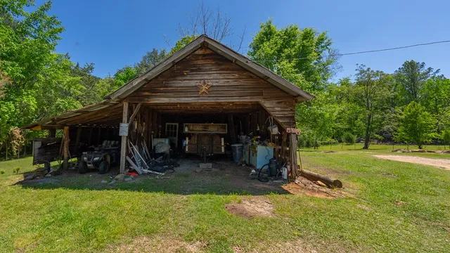 a view of a house with backyard and a tree