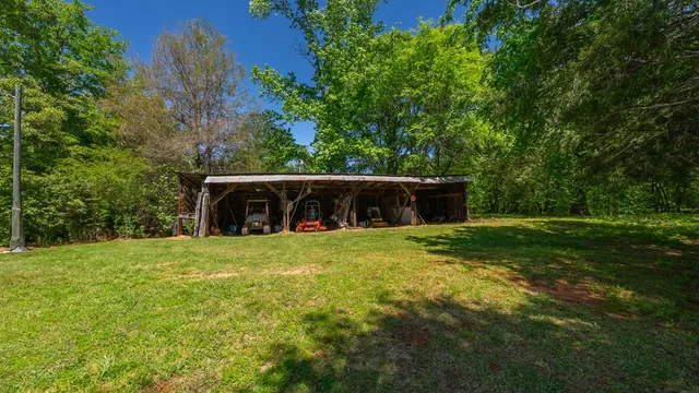 a view of a house with swimming pool and sitting area