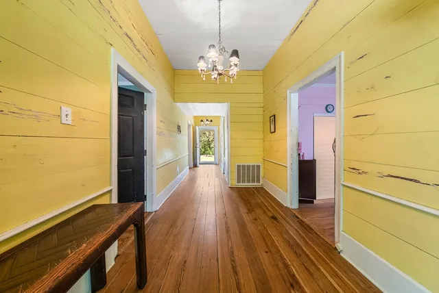 a view of a room with wooden floor and staircase