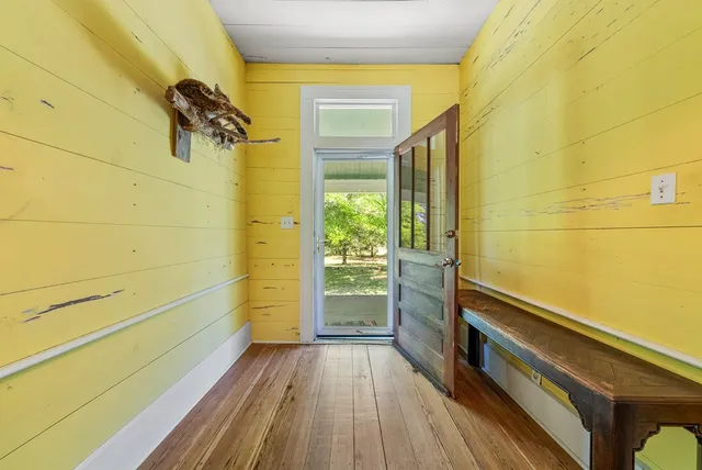 a bathroom with a wooden floor and a shower