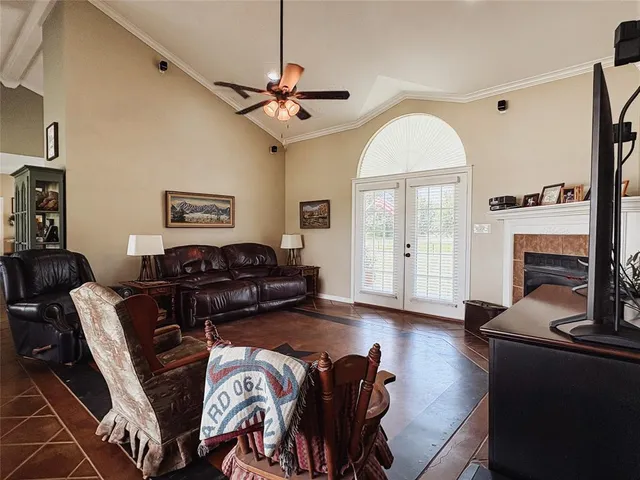 a living room with furniture a fireplace and a flat screen tv