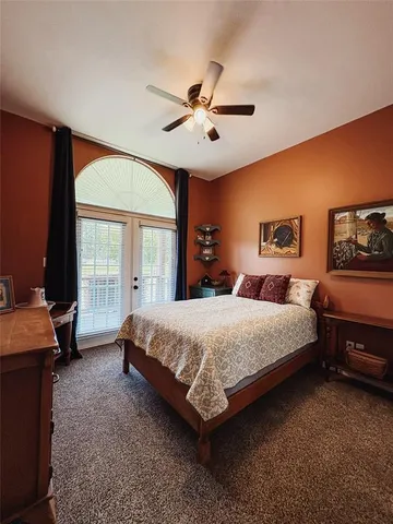 a bed room with a bed and a large window