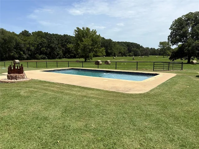 a view of a swimming pool with a yard