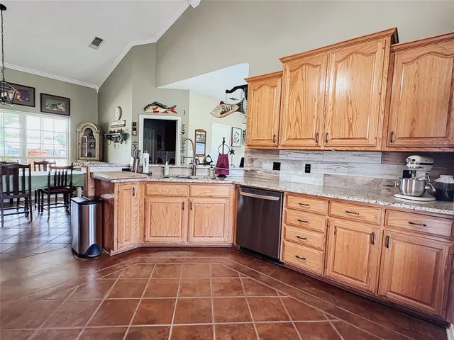 a kitchen with a sink window and cabinets