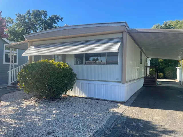 a view of a house with a yard and garage