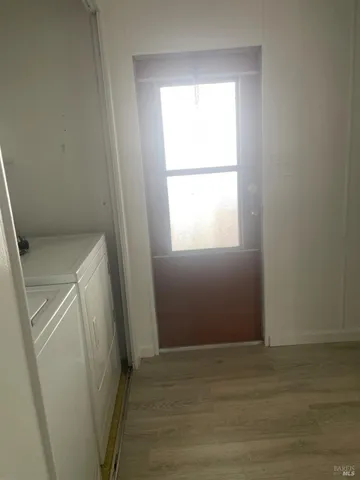 a view of a room with wooden floor and window