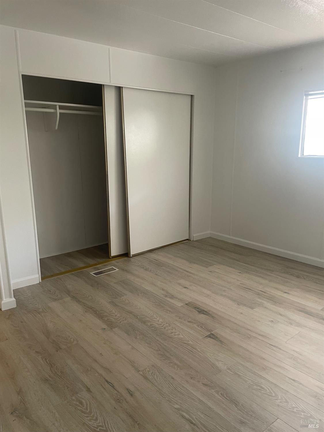 94 Buckwood Place Santa Rosa, CA 95409 - Photo 15 of 25 an empty room with wooden floor and closet area