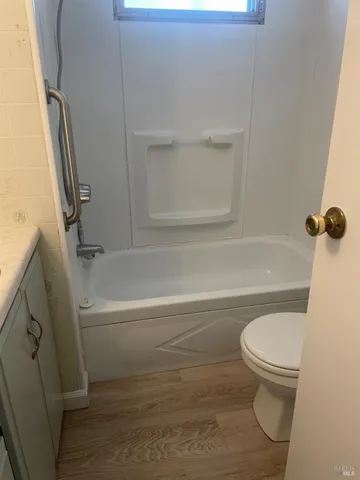 a bathroom with a toilet and a tub