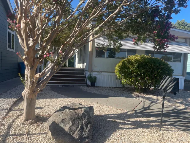 a view of a backyard with sitting area