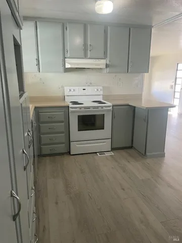 a kitchen with cabinets appliances and a counter top