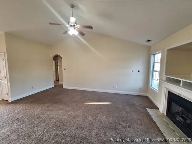 a view of a livingroom with a ceiling fan and window
