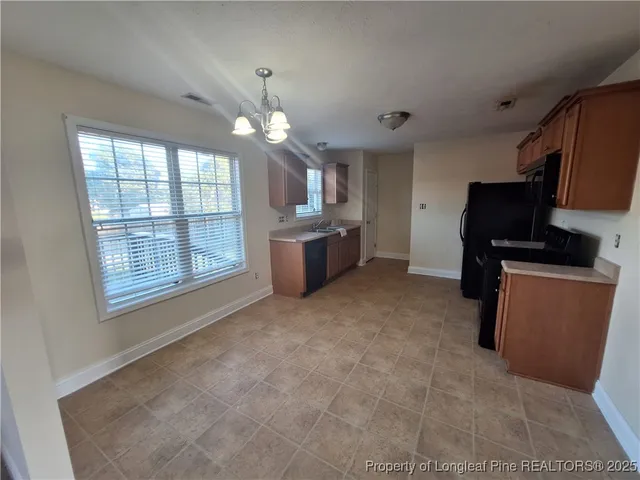 a living room with furniture a chandelier and a flat screen tv