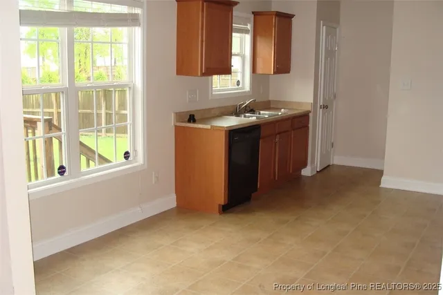 a kitchen with stainless steel appliances granite countertop a sink stove and a refrigerator