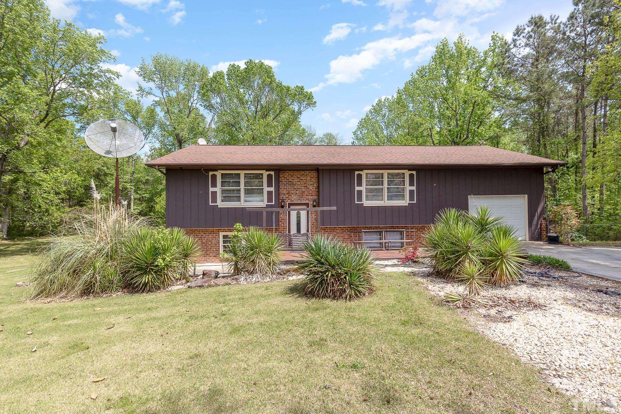 435 Temple Road Bunnlevel, NC 28323 - Photo 1 of 32 a front view of a house with garden