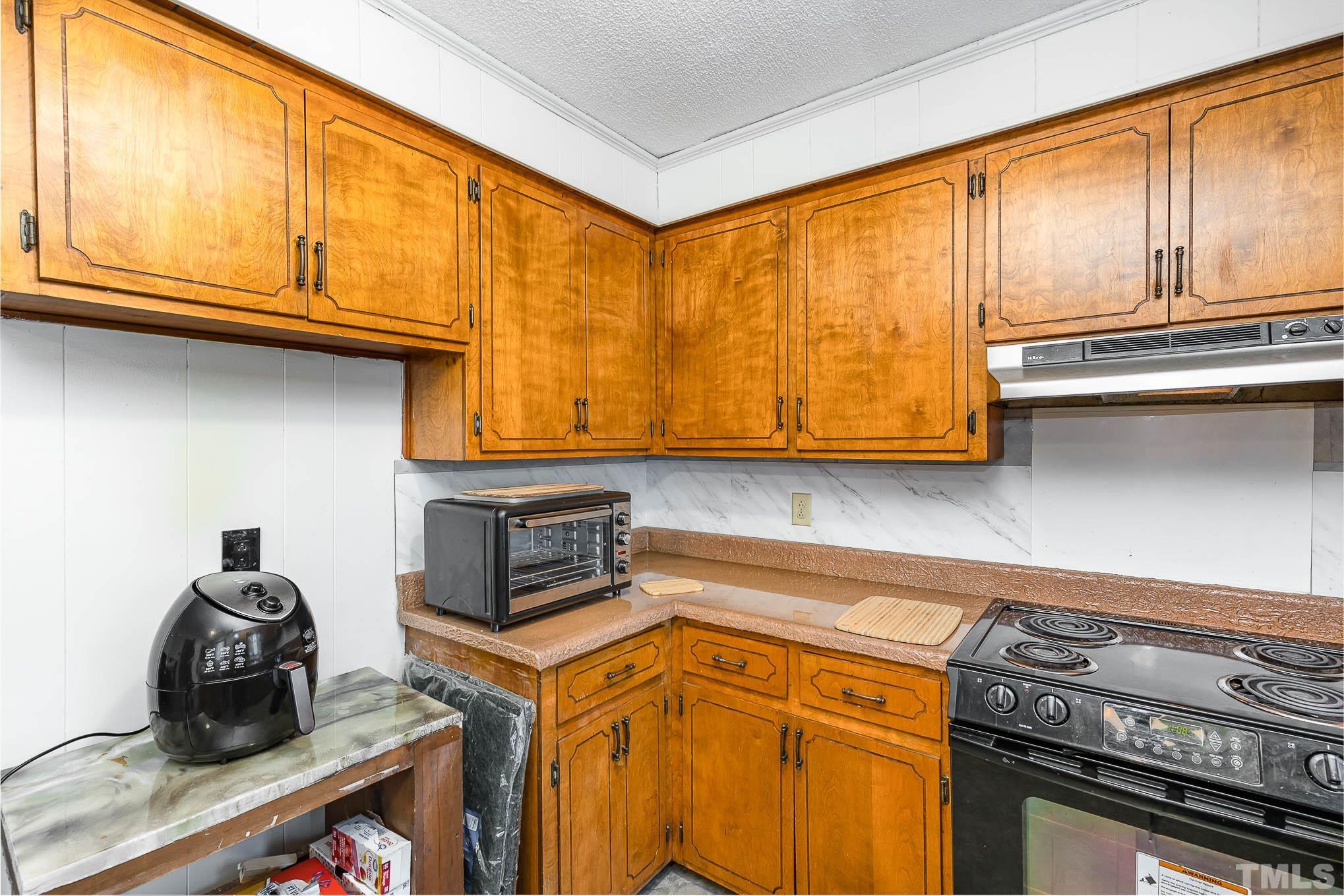 435 Temple Road Bunnlevel, NC 28323 - Photo 12 of 32 a kitchen with stainless steel appliances granite countertop a stove and a sink