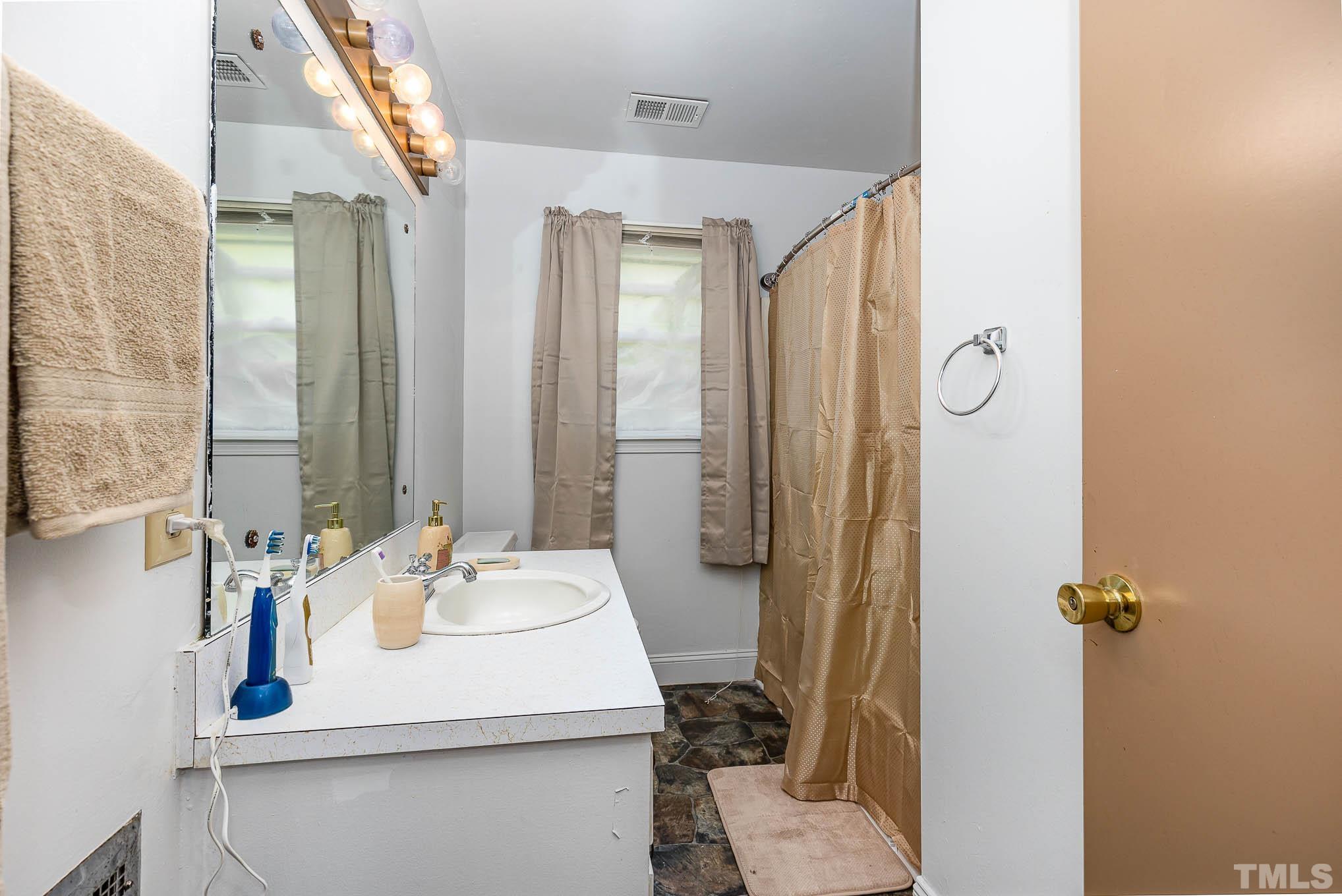 435 Temple Road Bunnlevel, NC 28323 - Photo 16 of 32 a bathroom with a sink toilet and shower