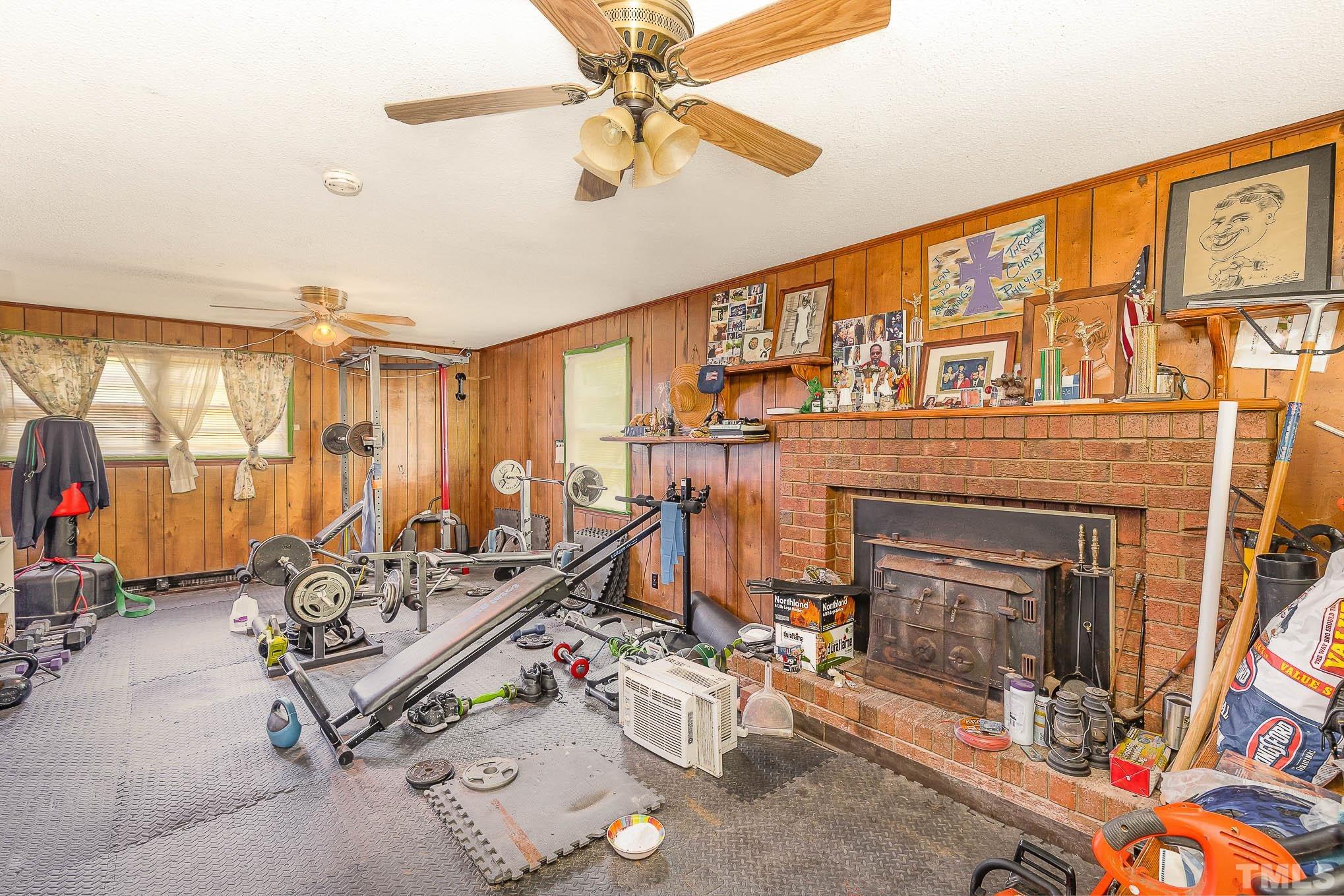 435 Temple Road Bunnlevel, NC 28323 - Photo 25 of 32 a living room with furniture a fireplace and a flat screen tv