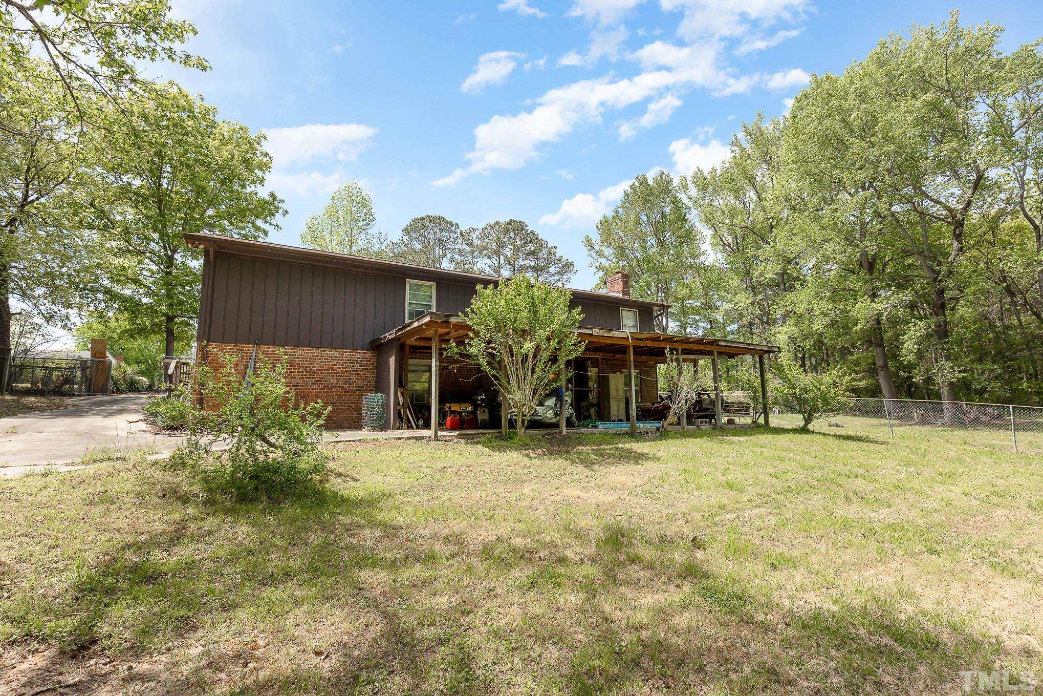 435 Temple Road Bunnlevel, NC 28323 - Photo 28 of 32 a view of a house with a big yard and large trees