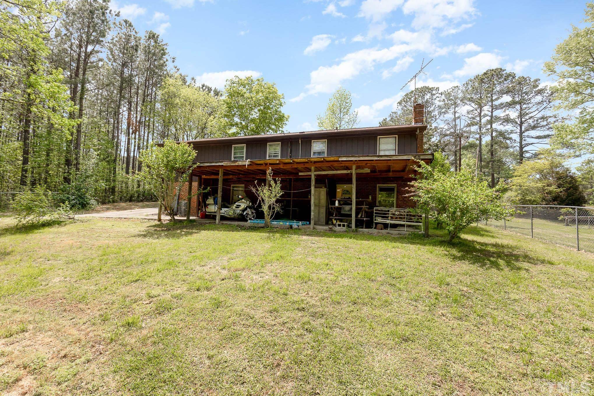 435 Temple Road Bunnlevel, NC 28323 - Photo 30 of 32 a view of a house with a yard and sitting area
