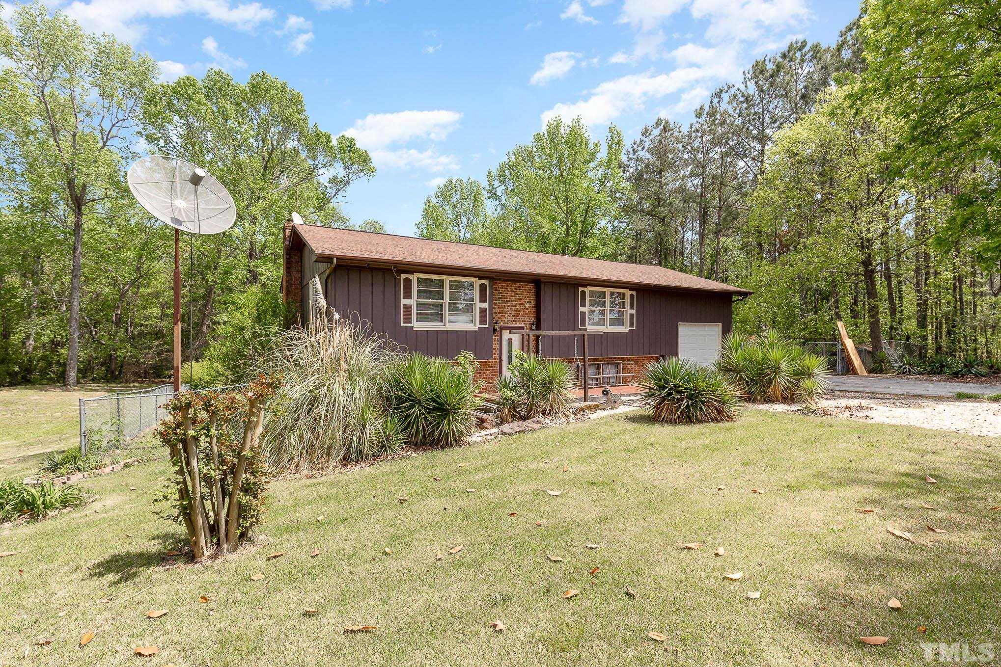 435 Temple Road Bunnlevel, NC 28323 - Photo 3 of 32 a view of a house with a yard and potted plants
