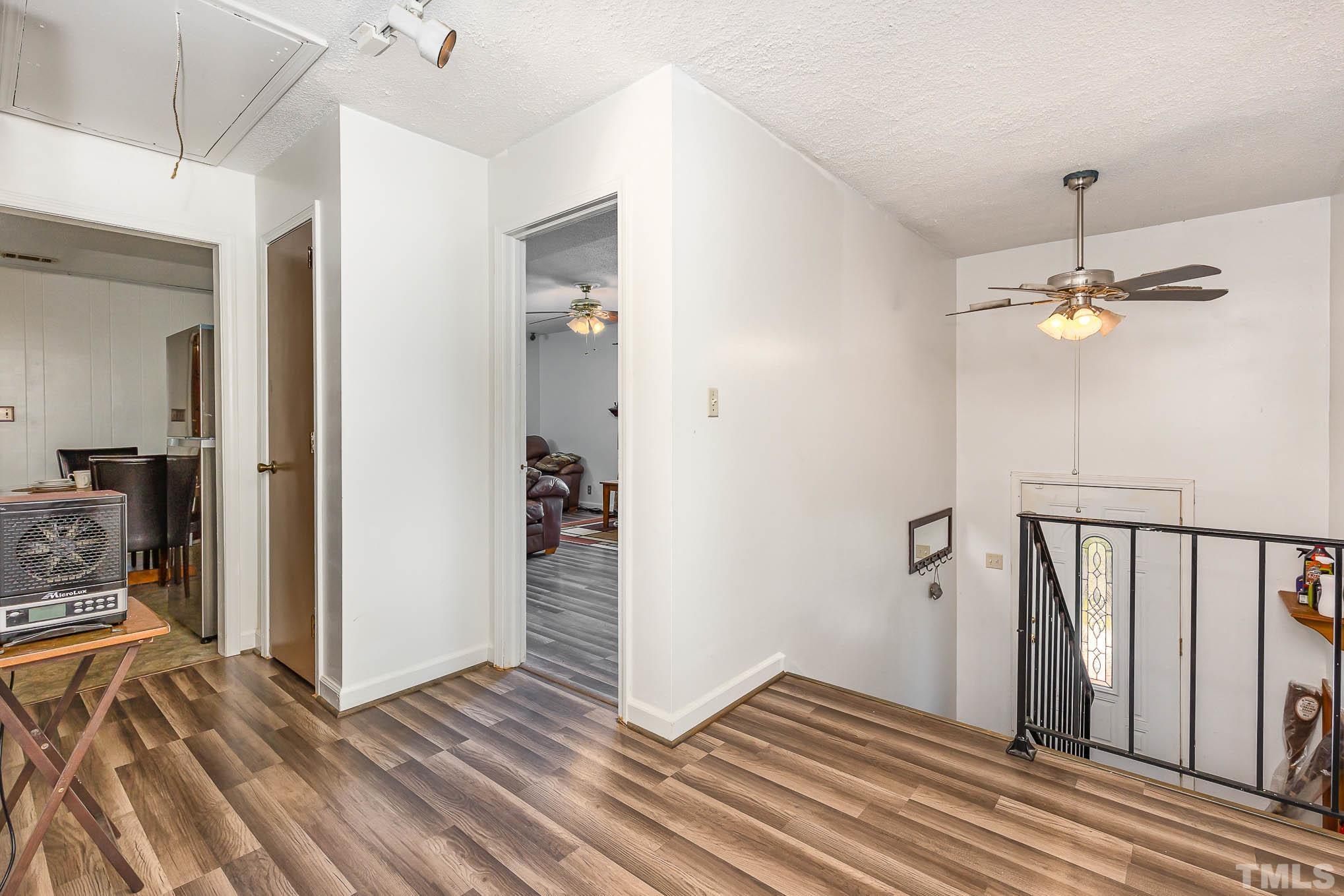 435 Temple Road Bunnlevel, NC 28323 - Photo 4 of 32 wooden floor in an empty room with a mirror