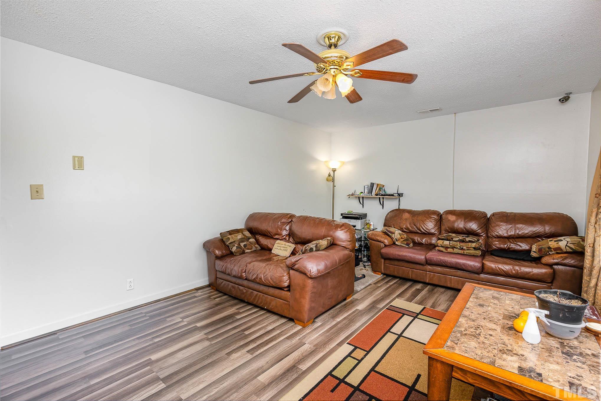 435 Temple Road Bunnlevel, NC 28323 - Photo 6 of 32 a living room with furniture and a wooden floor