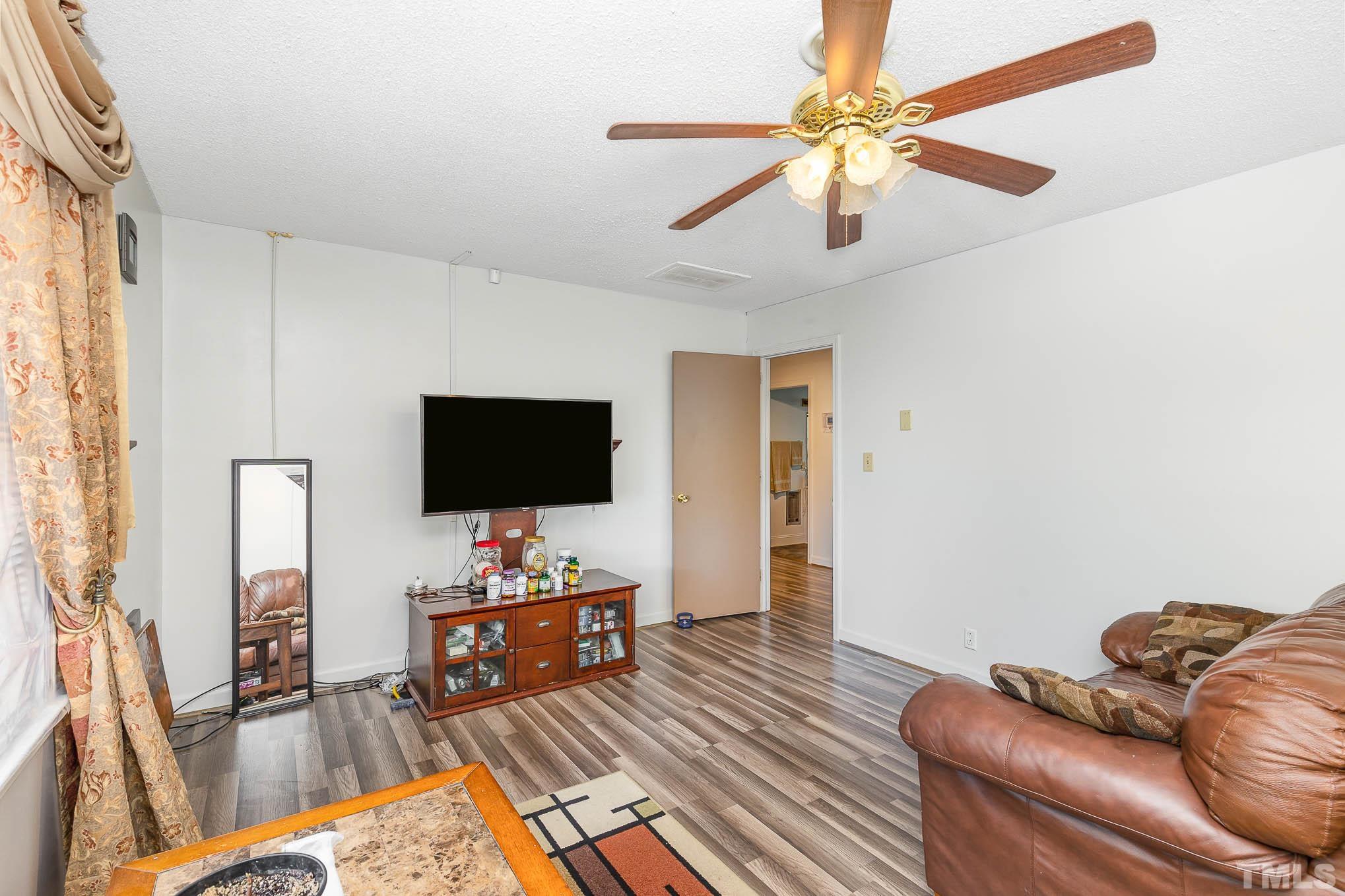 435 Temple Road Bunnlevel, NC 28323 - Photo 7 of 32 a living room with furniture and a flat screen tv