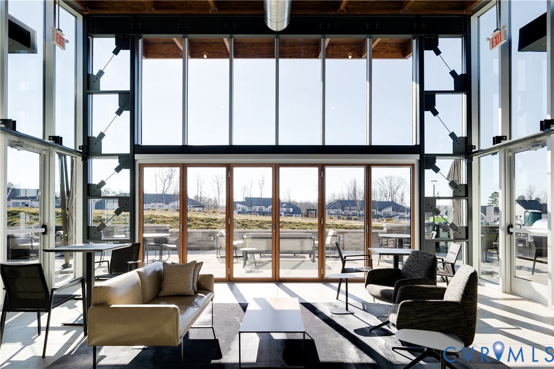 4116 Ebbies Crossing Midlothian, VA 23112 - Photo 31 of 42 a living room with furniture and floor to ceiling windows