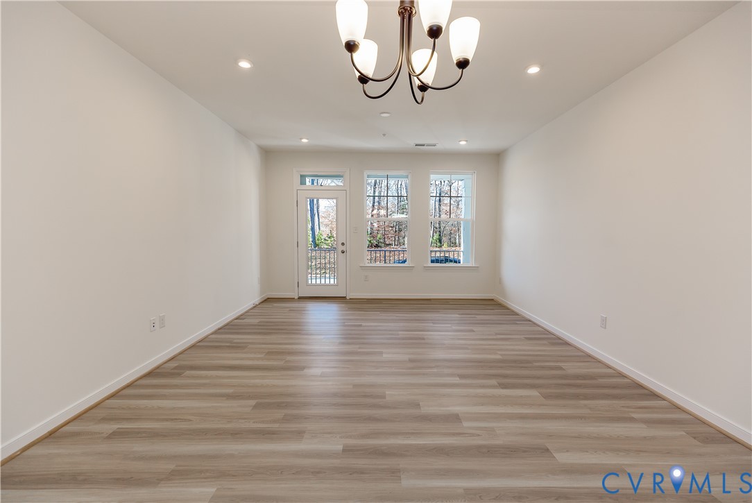 4116 Ebbies Crossing Midlothian, VA 23112 - Photo 7 of 42 wooden floor in an empty room with a window
