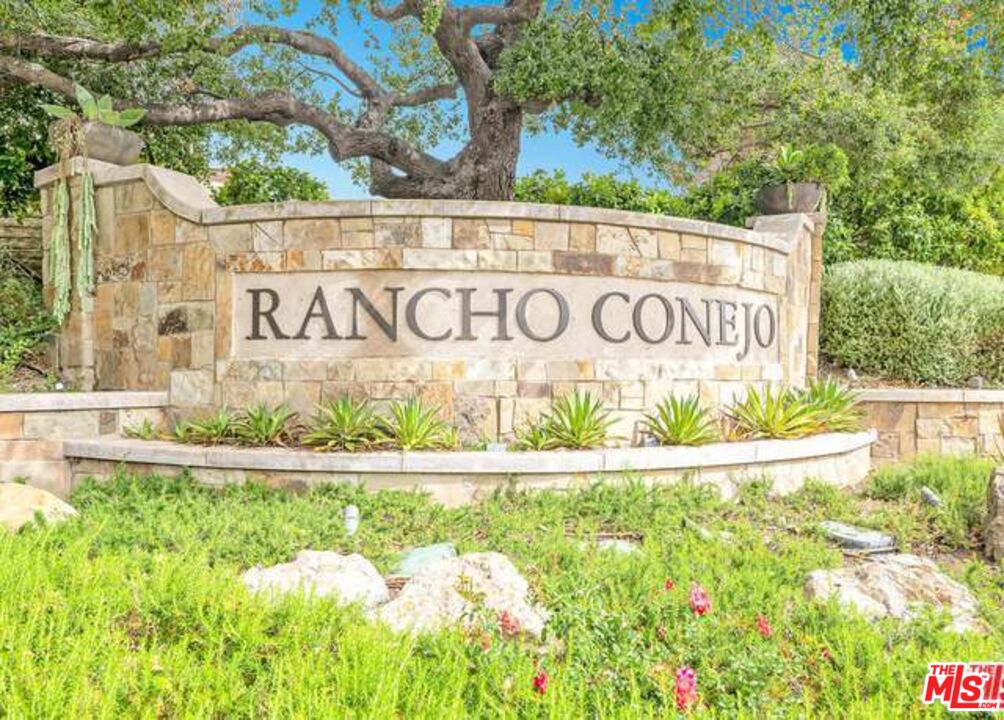 a white sign that is on the side of a building