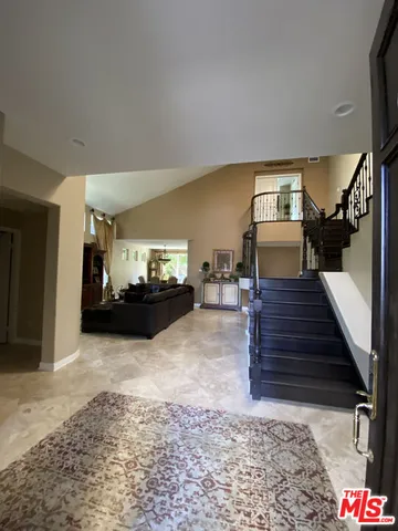 a living room with furniture and a rug